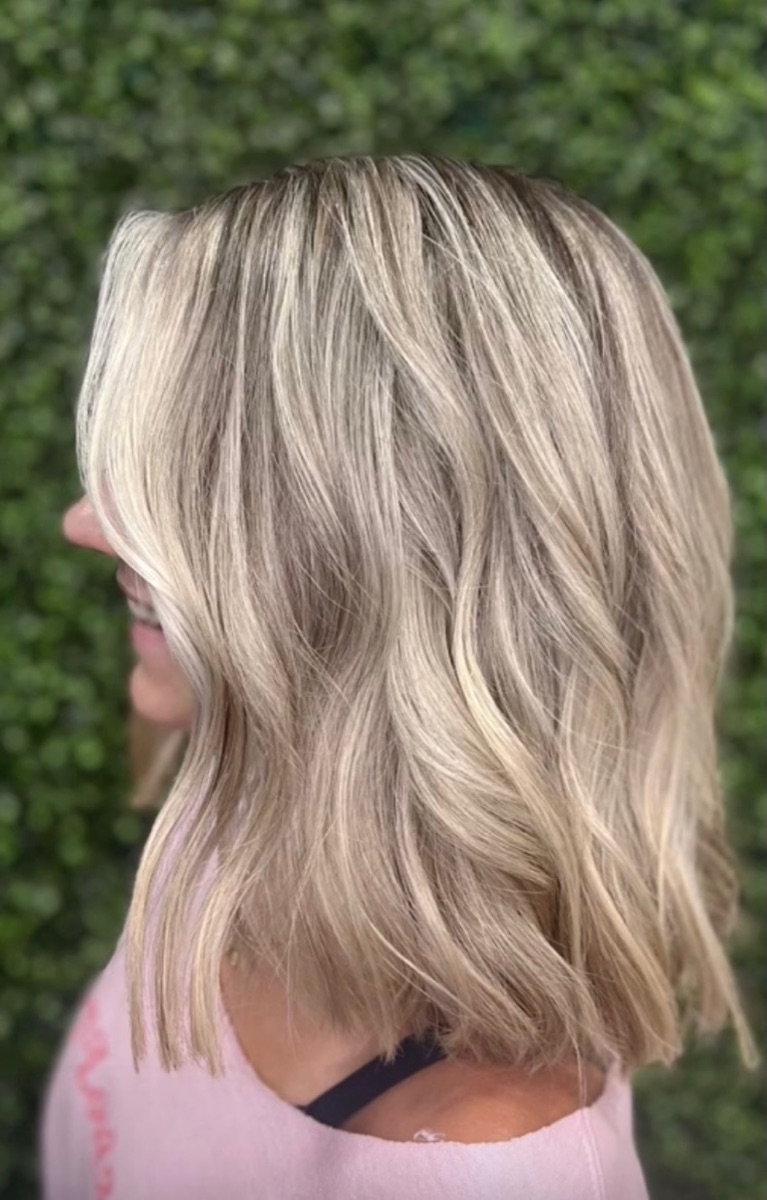 Ash blonde balayage on a shoulder-length wavy bob at Moxi Hair Studio in McKinney, TX