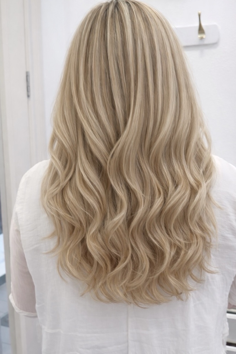 Blonde highlights on long curled hair at Moxi Hair Studio in McKinney, TX