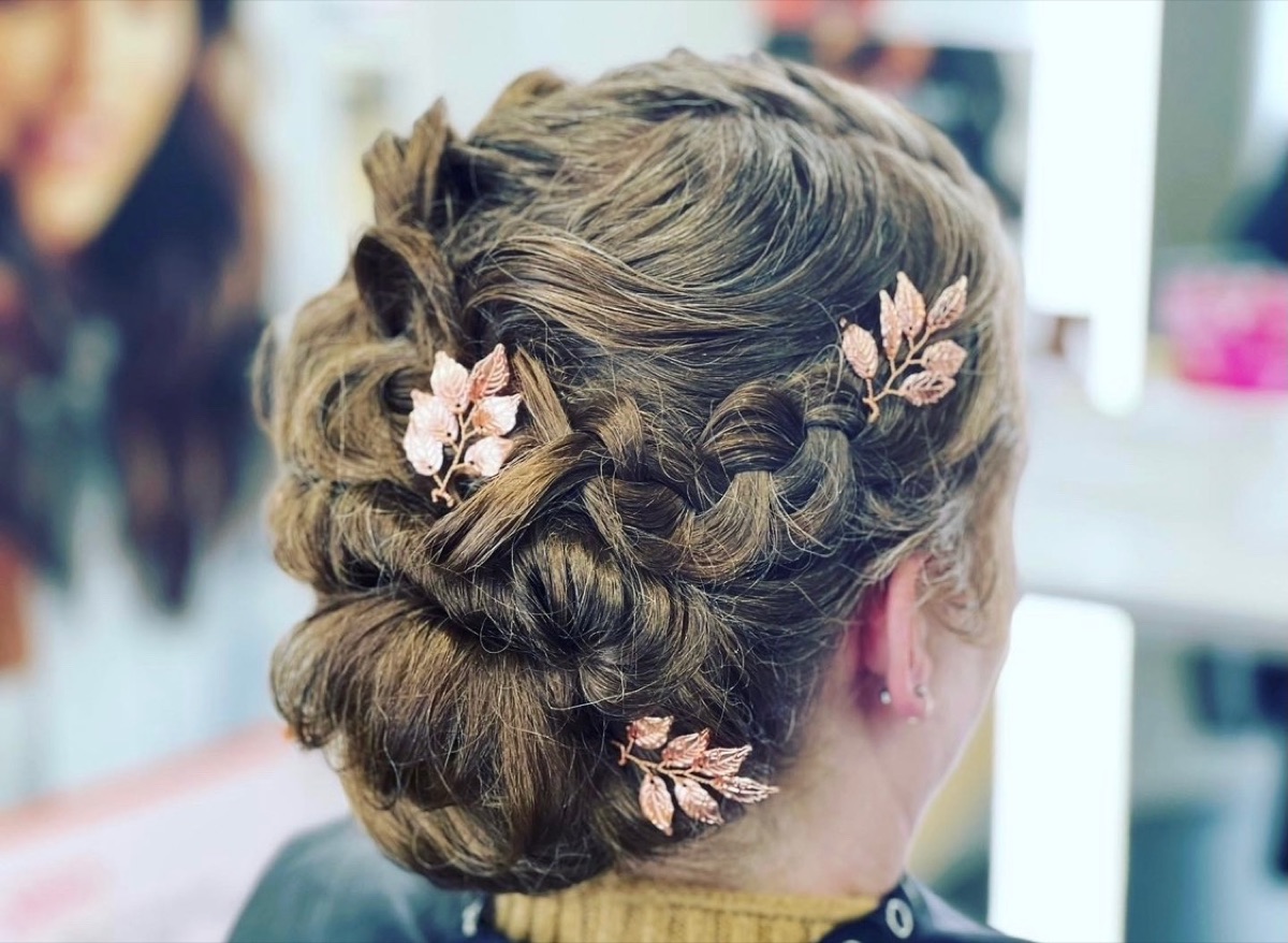 Braided updo with rose gold leaf hair accessories at Moxi Hair Studio in McKinney