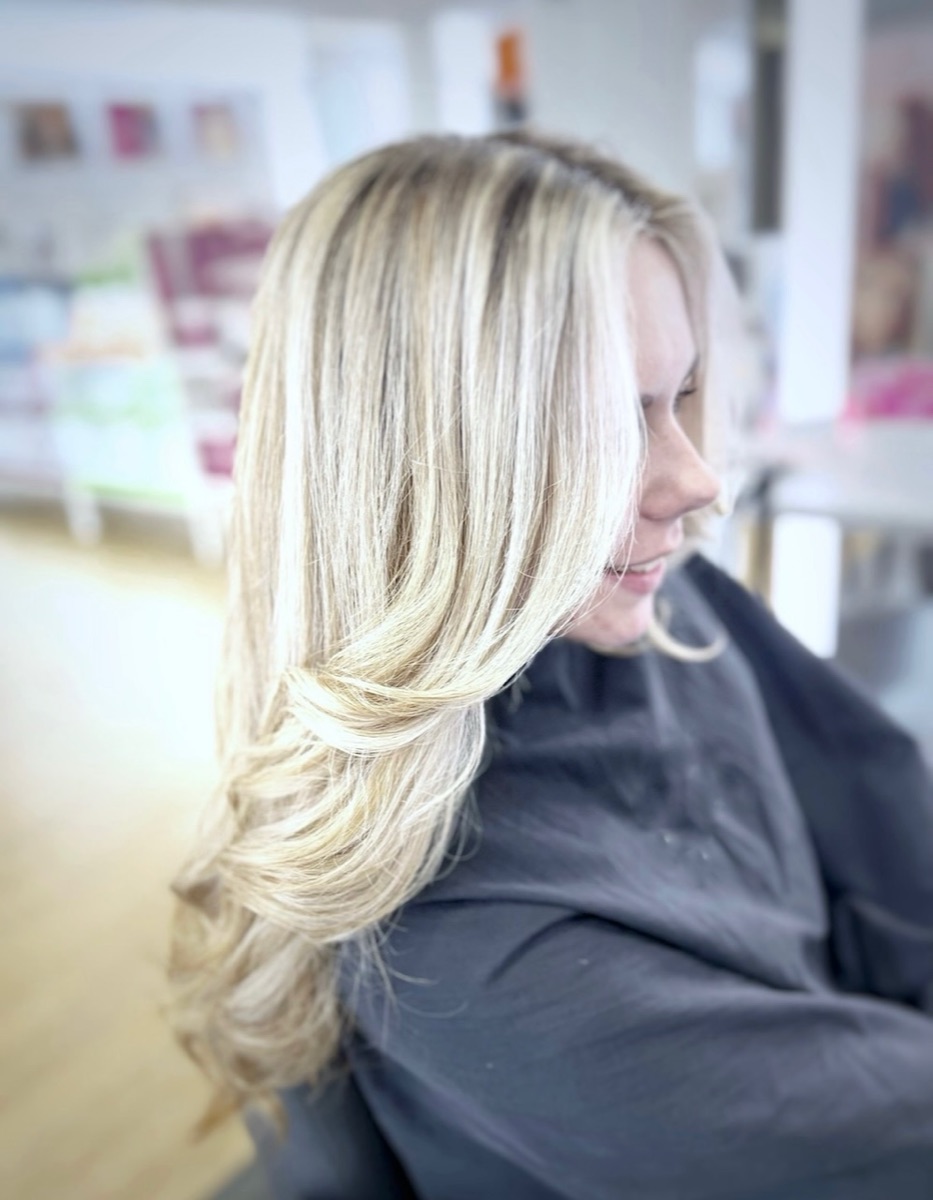 Platinum blonde highlights with a layered blowout at Moxi Hair Studio in McKinney, TX